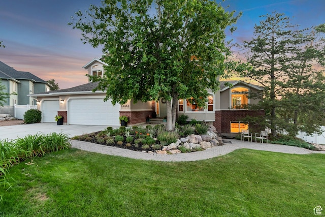 14012 S Osborne Ln E, Draper, UT 84020 - view of property hidden behind natural elements featuring brick siding, a front lawn, concrete driveway, an attached garage, and roof with shingles