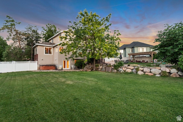 14012 S Osborne Ln E, Draper, UT 84020 - back of property at dusk with a hot tub, a pergola, stucco siding, and a patio
