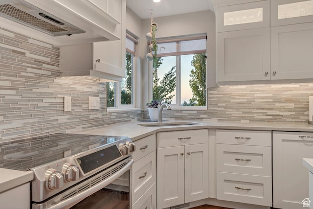 14012 S Osborne Ln E, Draper, UT 84020 - kitchen with electric range, decorative backsplash, white cabinets, light countertops, and healthy amount of natural light