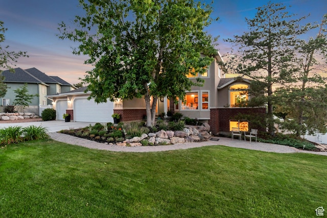 14012 S Osborne Ln E, Draper, UT 84020 - view of front of property featuring driveway, a yard, a garage, and brick siding