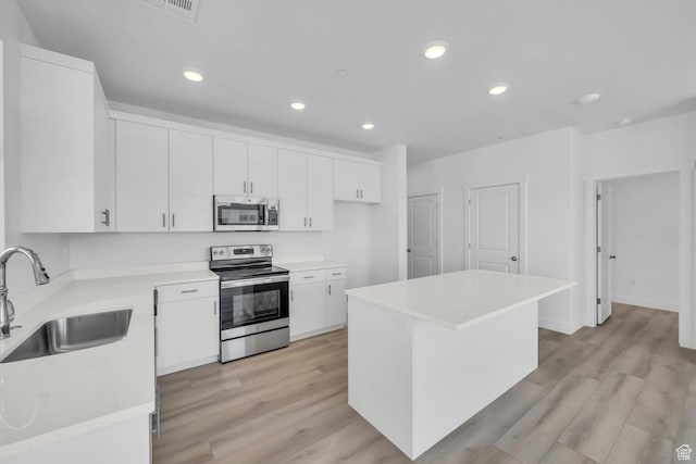 5599 S Carnelian Pkwy Unit 205, St George, UT 84790 - kitchen with appliances with stainless steel finishes, light wood-style flooring, white cabinets, light countertops, and recessed lighting
