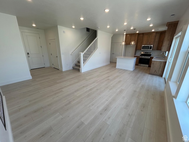564 N 800 W, Smithfield, UT 84335 - kitchen featuring stainless steel appliances, open floor plan, light countertops, light wood-style floors, and recessed lighting