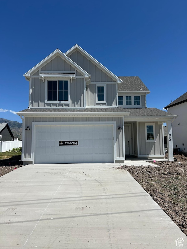 564 N 800 W, Smithfield, UT 84335 - view of front facade with board and batten siding, an attached garage, driveway, and a shingled roof