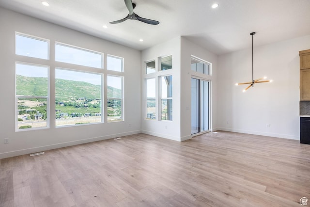 424 W Ascent Dr Unit 254, Hideout, UT 84036 - unfurnished living room featuring a chandelier, recessed lighting, ceiling fan, light wood finished floors, and a mountain view