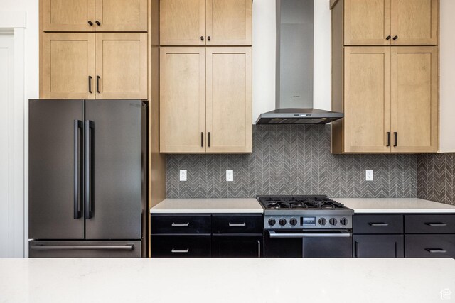 424 W Ascent Dr Unit 254, Hideout, UT 84036 - kitchen featuring freestanding refrigerator, wall chimney exhaust hood, range with gas stovetop, and light countertops