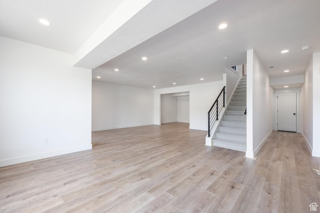424 W Ascent Dr Unit 254, Hideout, UT 84036 - unfurnished living room with recessed lighting, stairway, and light wood-style flooring