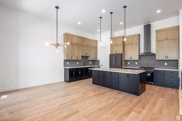 424 W Ascent Dr Unit 254, Hideout, UT 84036 - kitchen featuring wall chimney exhaust hood, high end stainless steel range, freestanding refrigerator, light countertops, and a kitchen island