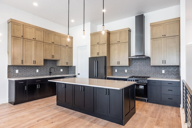424 W Ascent Dr Unit 254, Hideout, UT 84036 - kitchen featuring wall chimney exhaust hood, freestanding refrigerator, high end stainless steel range, a center island, and light countertops