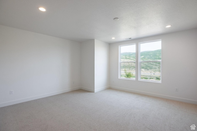 424 W Ascent Dr Unit 254, Hideout, UT 84036 - spare room with light colored carpet, recessed lighting, and a textured ceiling
