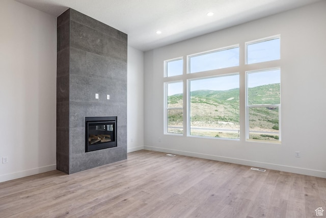 424 W Ascent Dr Unit 254, Hideout, UT 84036 - unfurnished living room featuring a fireplace, light wood-style flooring, and recessed lighting