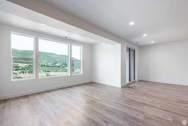 424 W Ascent Dr Unit 254, Hideout, UT 84036 - unfurnished room featuring recessed lighting, light wood finished floors, and a textured ceiling