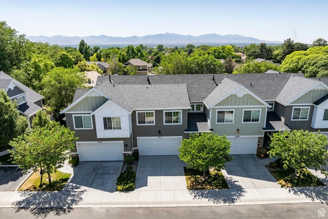 7902 S Farm House Ln E, Midvale, UT 84047 - view of front facade with board and batten siding, an attached garage, driveway, stone siding, and a shingled roof