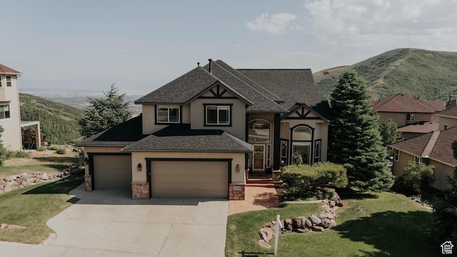 1628 E Lone Oak Dr, Draper, UT 84020 - view of front facade with a shingled roof, concrete driveway, a front lawn, and stone siding