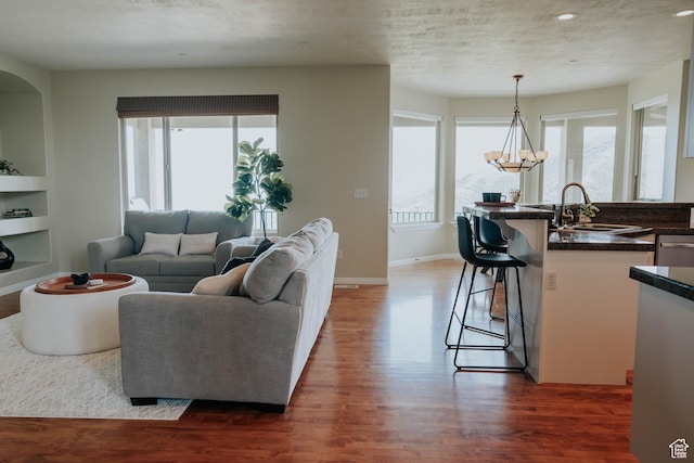 1628 E Lone Oak Dr, Draper, UT 84020 - living area with wood finished floors, built in shelves, recessed lighting, and a chandelier