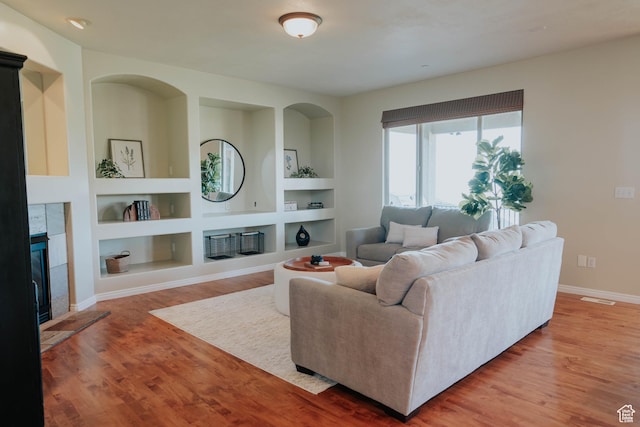 1628 E Lone Oak Dr, Draper, UT 84020 - living area featuring a tiled fireplace, wood finished floors, and built in features