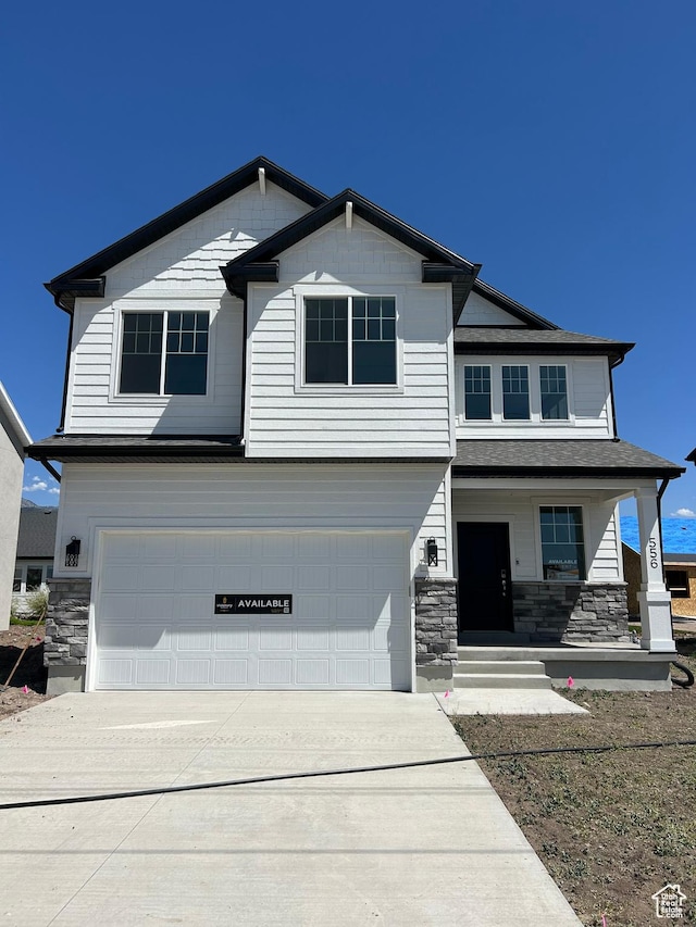 556 N 800 W, Smithfield, UT 84335 - craftsman-style house featuring a garage, stone siding, concrete driveway, and a porch