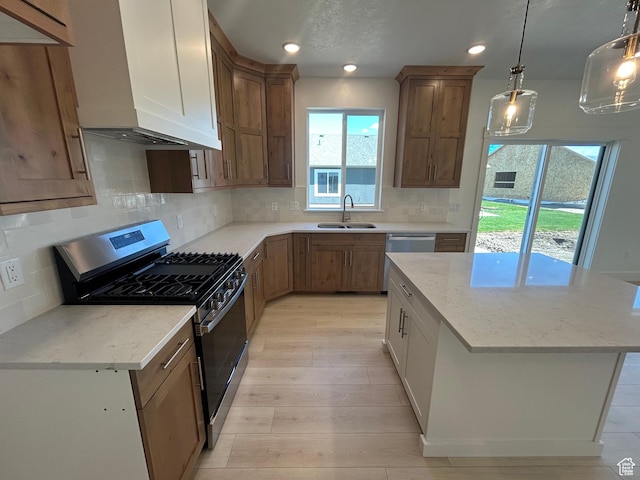 556 N 800 W, Smithfield, UT 84335 - kitchen with stainless steel appliances, custom range hood, a center island, light wood-type flooring, and light stone counters