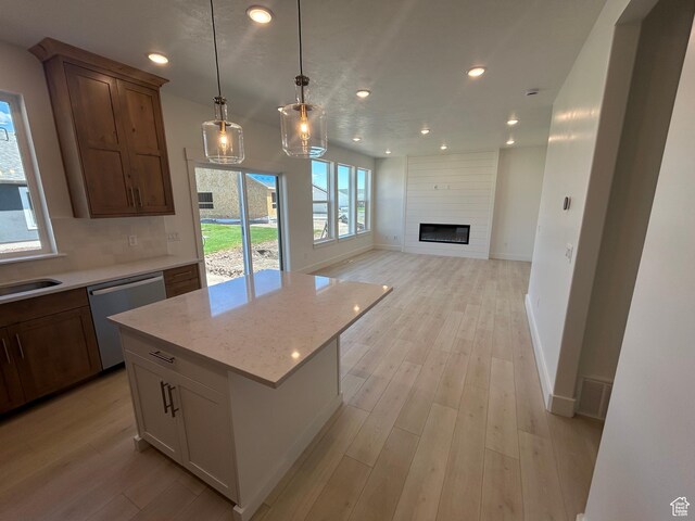 556 N 800 W, Smithfield, UT 84335 - kitchen with dishwasher, recessed lighting, light wood-style floors, hanging light fixtures, and a fireplace