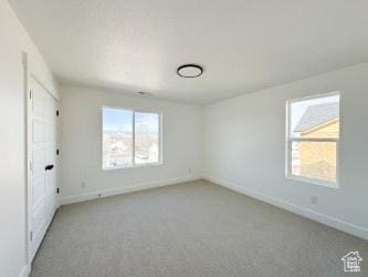 1805 N 70 W, Tooele, UT 84074 - unfurnished bedroom with baseboards and light colored carpet