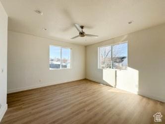 1805 N 70 W, Tooele, UT 84074 - unfurnished room with plenty of natural light, a ceiling fan, and wood finished floors