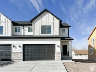 1805 N 70 W, Tooele, UT 84074 - modern farmhouse style home featuring board and batten siding, an attached garage, driveway, and stone siding