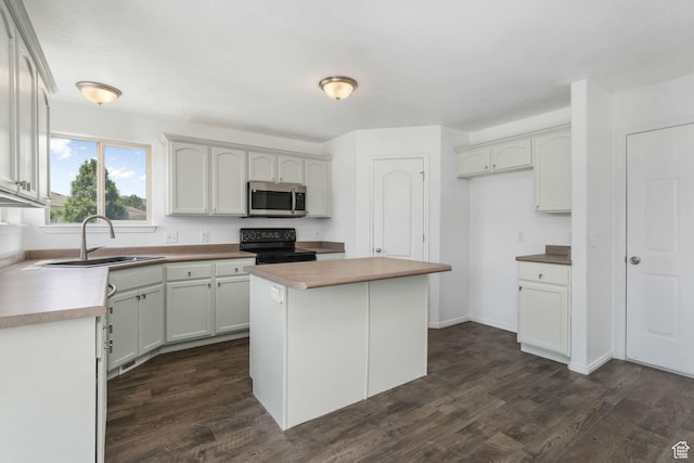 4004 N Shelter Cv W, Lehi, UT 84043 - kitchen with stainless steel microwave, black / electric stove, dark wood-style floors, a kitchen island, and white cabinetry