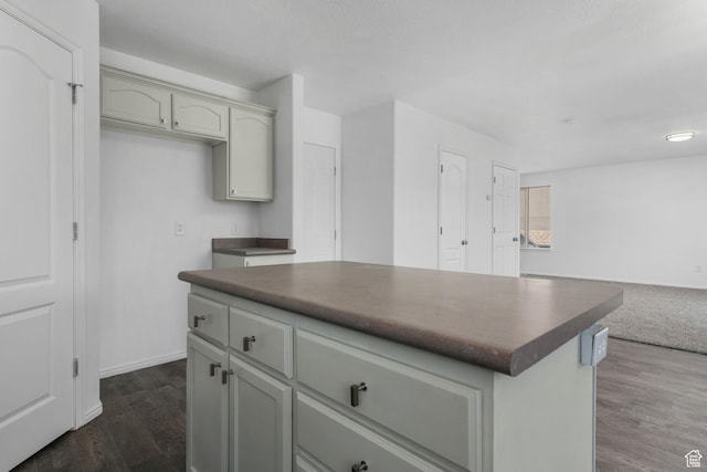 4004 N Shelter Cv W, Lehi, UT 84043 - kitchen with dark countertops, open floor plan, a kitchen island, and dark wood-style flooring