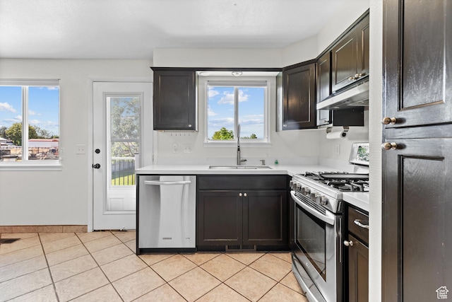2124 W 7125 S, West Jordan, UT 84084 - kitchen with appliances with stainless steel finishes, under cabinet range hood, light countertops, and light tile patterned floors