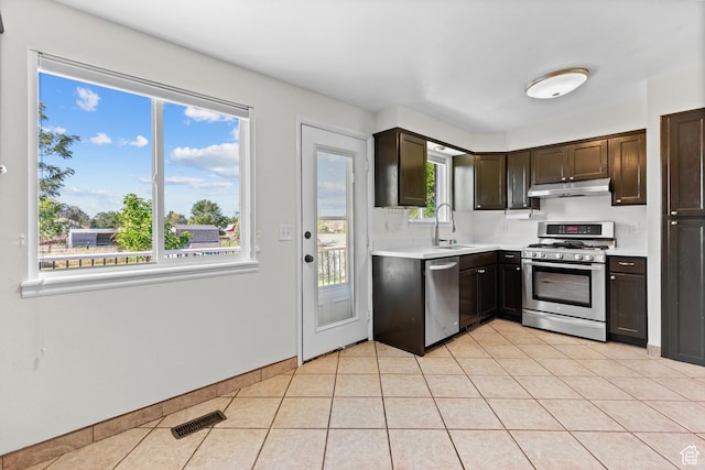 2124 W 7125 S, West Jordan, UT 84084 - kitchen featuring appliances with stainless steel finishes, under cabinet range hood, light countertops, dark brown cabinets, and light tile patterned flooring