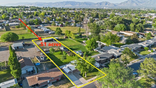 2124 W 7125 S, West Jordan, UT 84084 - aerial view of residential area featuring a mountainous background and property parcel outlined