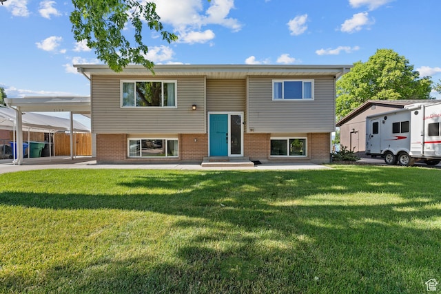 2124 W 7125 S, West Jordan, UT 84084 - split foyer home with brick siding, entry steps, a front yard, and a carport