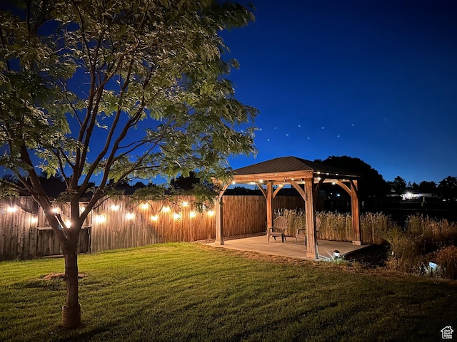 2124 W 7125 S, West Jordan, UT 84084 - yard at twilight featuring a gazebo, a patio, and a fenced backyard