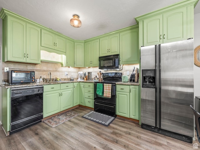 4742 S 700 E Unit 84, Salt Lake City, UT 84107 - kitchen with black appliances, wood finished floors, tasteful backsplash, and light stone countertops