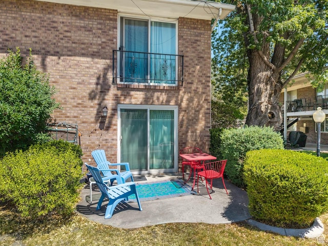 4742 S 700 E Unit 84, Salt Lake City, UT 84107 - back of house featuring brick siding, a balcony, and a patio