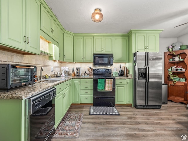 4742 S 700 E Unit 84, Salt Lake City, UT 84107 - kitchen featuring black appliances, light wood-style floors, and decorative backsplash