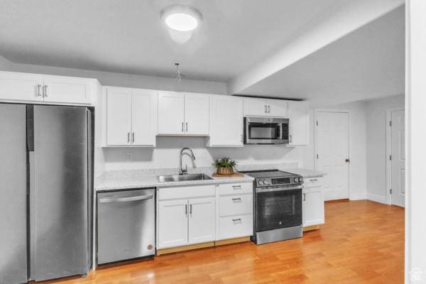 1342 S 1340 E, Spanish Fork, UT 84660 - kitchen featuring appliances with stainless steel finishes, light countertops, white cabinetry, and light wood-style floors