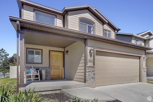 1541 N 25 E, Layton, UT 84041 - multi unit property featuring stone siding, a porch, concrete driveway, and a garage