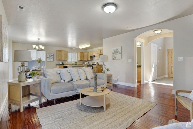 1541 N 25 E, Layton, UT 84041 - living area featuring arched walkways, wood-type flooring, and a chandelier