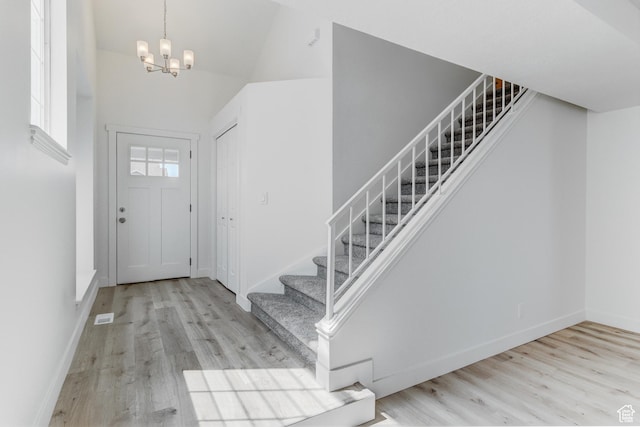 415 E Acoma Rd S, Midvale, UT 84047 - entryway featuring stairway, wood finished floors, a towering ceiling, and a chandelier