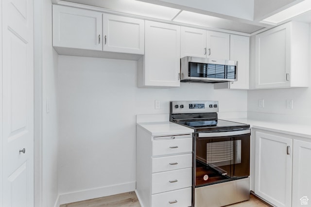 415 E Acoma Rd S, Midvale, UT 84047 - kitchen with stainless steel appliances, white cabinetry, light countertops, and light wood finished floors