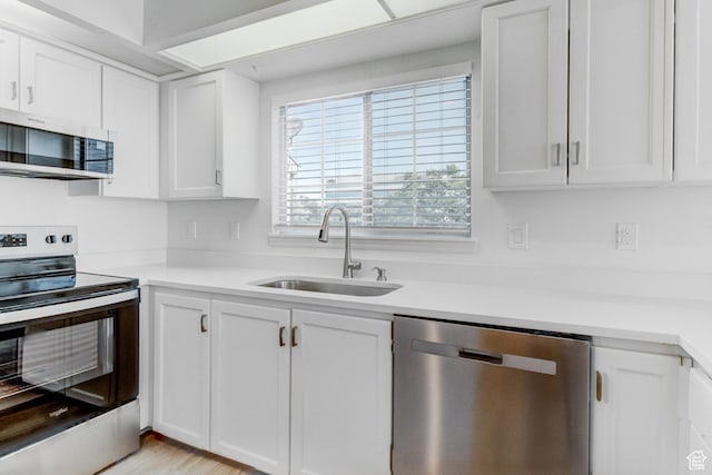 415 E Acoma Rd S, Midvale, UT 84047 - kitchen with appliances with stainless steel finishes, white cabinets, and light countertops