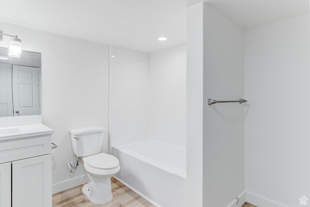 415 E Acoma Rd S, Midvale, UT 84047 - bathroom featuring vanity, wood finished floors, recessed lighting, and washtub / shower combination
