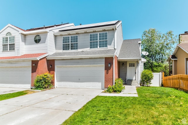 415 E Acoma Rd S, Midvale, UT 84047 - view of front of house featuring an attached garage, concrete driveway, solar panels, and brick siding