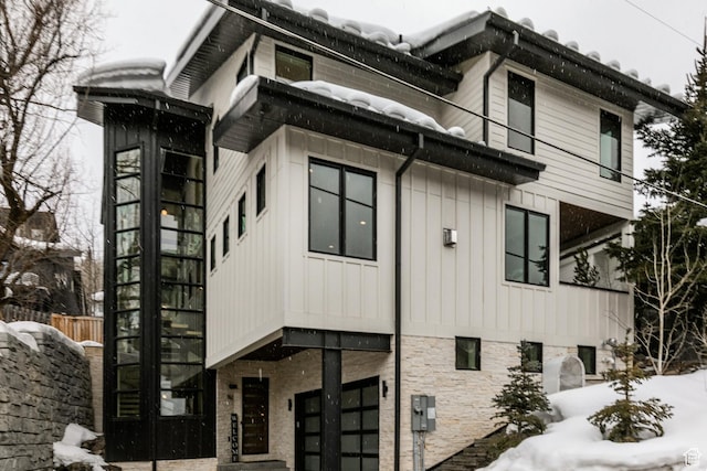 552 Deer Valley Dr, Park City, UT 84060 - snow covered property with an attached garage and board and batten siding