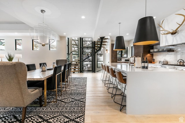 552 Deer Valley Dr, Park City, UT 84060 - dining room featuring stairway, healthy amount of natural light, light wood-style floors, recessed lighting, and a chandelier