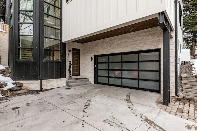 552 Deer Valley Dr, Park City, UT 84060 - property entrance featuring driveway, an attached garage, board and batten siding, and brick siding