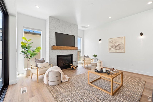5554 N Fox Canyon Rd, Lehi, UT 84043 - living area with light wood finished floors, a fireplace, and recessed lighting