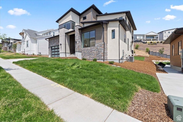 5554 N Fox Canyon Rd, Lehi, UT 84043 - contemporary house with stone siding, a residential view, a front lawn, and stucco siding
