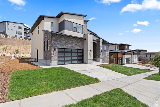 5554 N Fox Canyon Rd, Lehi, UT 84043 - modern home with stone siding, an attached garage, stucco siding, driveway, and a front lawn