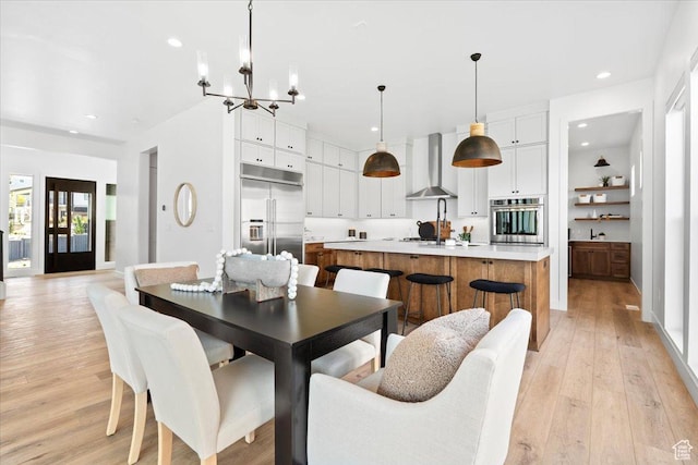 5554 N Fox Canyon Rd, Lehi, UT 84043 - dining room featuring light wood-style flooring, a chandelier, and recessed lighting